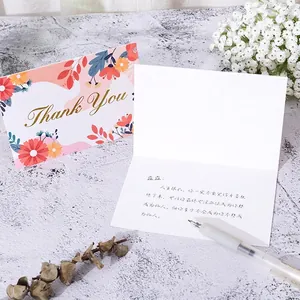 Floral thank you greeting card with gold lettering and blank interior for messages