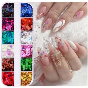 Close-up of 12-grid nail art glitter set with laser holographic heart shapes in varied colors