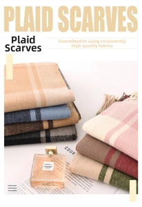 Detail of plaid scarves showing soft cashmere-like texture and classic tassel fringe trim