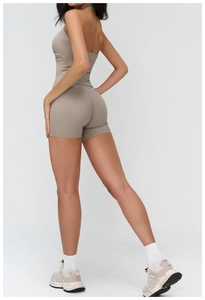 Rear view of taupe brushed yoga jumpsuit showing slim fit and hollow back design