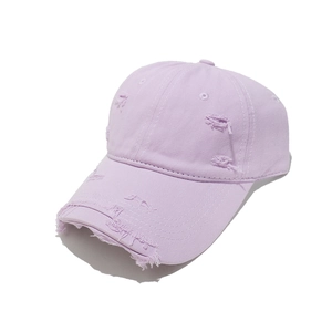 Detailed view of lavender cotton twill baseball cap with distressed brim and vintage textures