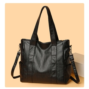 Black large capacity tote bag with adjustable shoulder strap and soft leather texture