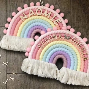 Detail of handmade macrame rainbow wall hanging with pastel colors and custom wooden name tag
