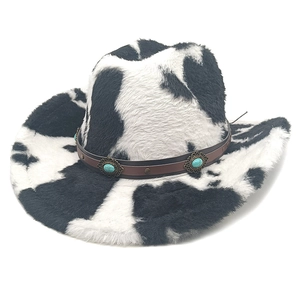 Detail of cow print cowboy hat showing plush texture and turquoise stone leather band