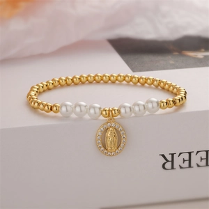 Detailed close-up of religious beaded bracelet with pearls and Virgin Mary medal pendant
