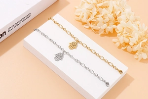 Detail of Hamsa Hand charm bracelets in gold and silver finish on display