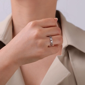Stainless steel ring featuring hollow cat paw patterns worn on finger for a stylish look