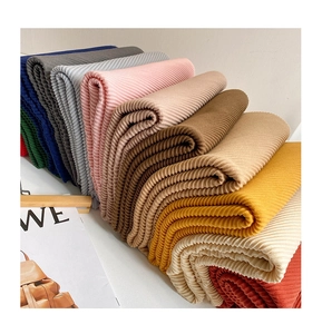 Detail showing various colors of pleated texture fabric scarves with accordion folds