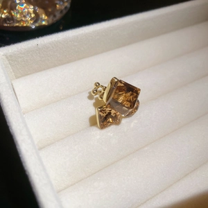 Macro shot of gold-plated square amber crystals ear clip with vintage geometric design