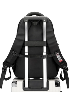 Black business backpack featuring a luggage strap for travel convenience on a suitcase