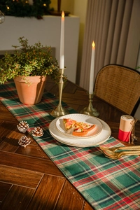 Detailed view of red and green plaid table runner with rustic cotton linen texture