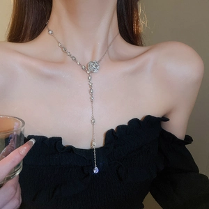 Close-up of a sparkling crystal flower necklace with a teardrop tassel pendant for women