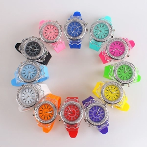 Macro shot of twelve colorful rhinestone jelly quartz watches arranged in a circular display