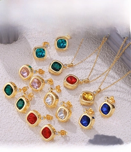 Macro view of colorful square cubic zirconia necklaces and earrings with gold PVD plating