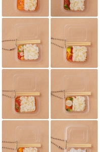 Detailed close-up of miniature food pendants with rice and varied dishes in tiny clear boxes