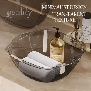 Modern semi-transparent dark grey washbasin with side handles on marble countertop