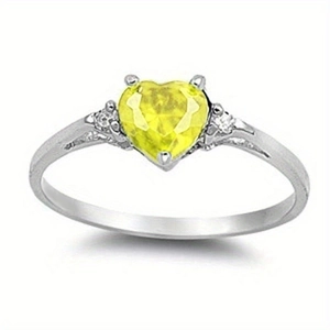 Macro shot of silver heart ring featuring a yellow center stone and side diamonds