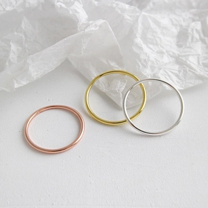Three-piece set of minimalist stackable rings in silver, gold, and rose gold finishes