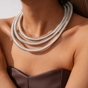 Detailed view of layered silver snake chain necklace with high-polish metallic texture