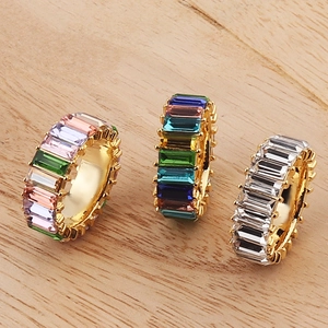 Three baguette-cut eternity rings in colorful crystals on a gold-plated copper base