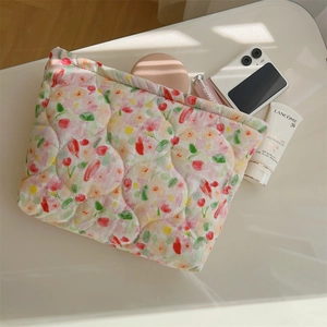 Detailed top view of quilted floral cosmetic bag showing storage capacity and soft cotton texture