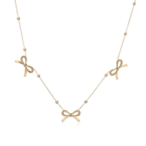 Detail of rose gold necklace featuring polished beads and three delicate bow pendants