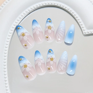 Unghie finte blu sfumate con gigli 3D e perle in stile francese elegante