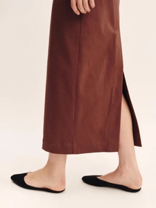 Detail view of a brown maxi dress featuring a side slit and textured cotton-linen fabric