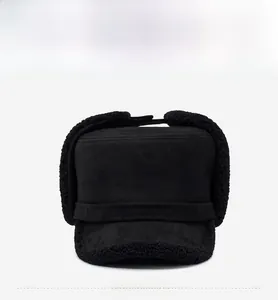 Detail of black winter aviator hat with plush faux lamb wool lining and suede finish