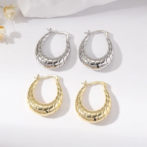 Textured gold and silver croissant hoop earrings set with minimalist diagonal grooves