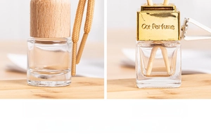 Detailed comparison of wooden and gold metal car perfume bottle caps with clips