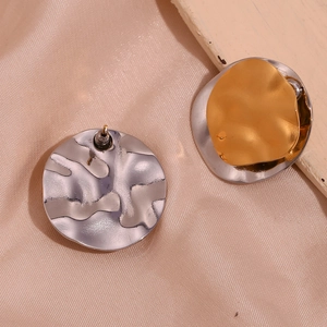 Detail of irregular textured two-tone 18K gold plated stainless steel stud earrings