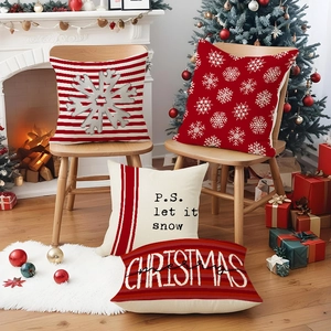 Set of 4 red Christmas snowflake linen pillow covers in a cozy home fireplace scene