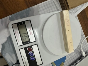 Detalle de la medición de peso de 19,5 g del brillo labial FAFAMGON en báscula digital