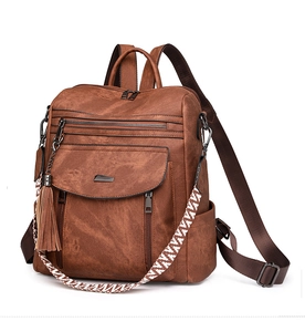 Detail of brown PU leather backpack featuring zipper pockets and woven pattern shoulder strap