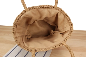 Top-down view of woven straw tote bag showing spacious fabric lining and interior texture