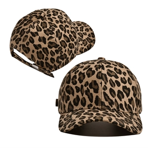 Detail of leopard print baseball cap featuring cotton twill texture and metal back buckle
