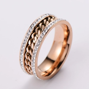 Detail of rose gold knotted ring featuring twisted chain texture and pavé set zircons