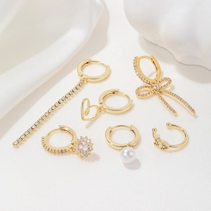 Elegant gold bow heart earrings set with tassels pearls and cubic zirconia stones