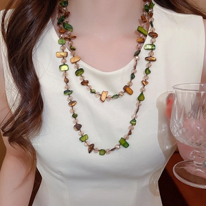 Close-up of double-layer necklace with irregular colorful beads and crystals on a model