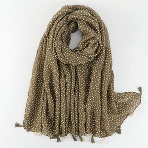 Detail of floral print on olive green cotton linen scarf with elegant tassel edges