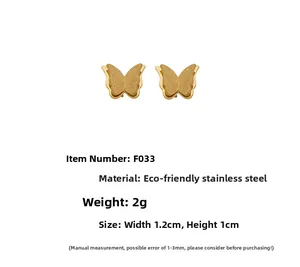 Detail view of gold butterfly stud earrings made of brushed stainless steel with size specs