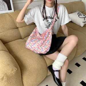 Floral canvas tote bag for women shown in a lifestyle scene on a yellow sofa