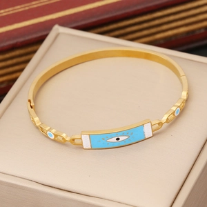 Gold stainless steel evil eye bangle with light blue enamel finish in a jewelry box