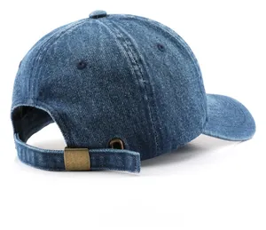 Detail view of denim baseball cap with retro metal buckle and adjustable back strap