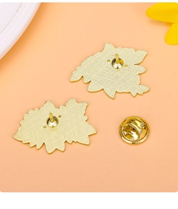 Macro view of gold-plated alloy brooch back with butterfly clasp and anti-slip texture