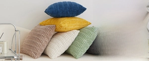 Close-up of multicolored textured corduroy plush sofa pillows in a modern living room