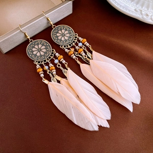 Bohemian drop oil earrings with pink feathers, hollow round patterns and wooden beads