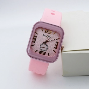 Detail of pink silicone strap and square rose gold dial on women's quartz watch