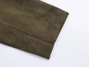 Detailed macro shot of olive green suede fabric texture and professional stitching